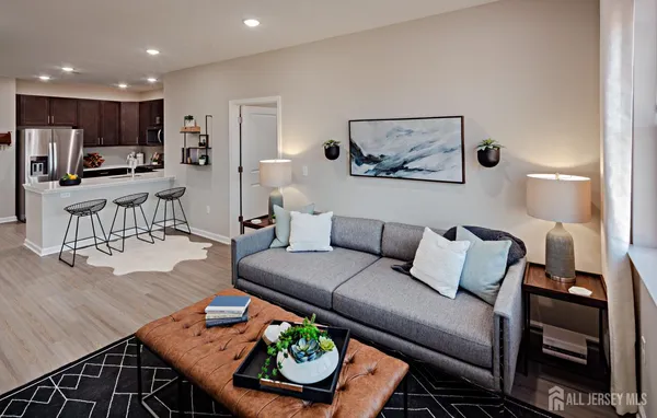 a living room with furniture and kitchen view