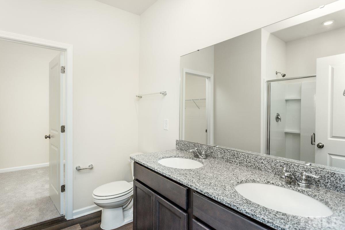 3521 Strawberry Patch Row Raleigh, NC 27604 - Photo 4 of 11 a bathroom with a granite countertop sink toilet and shower