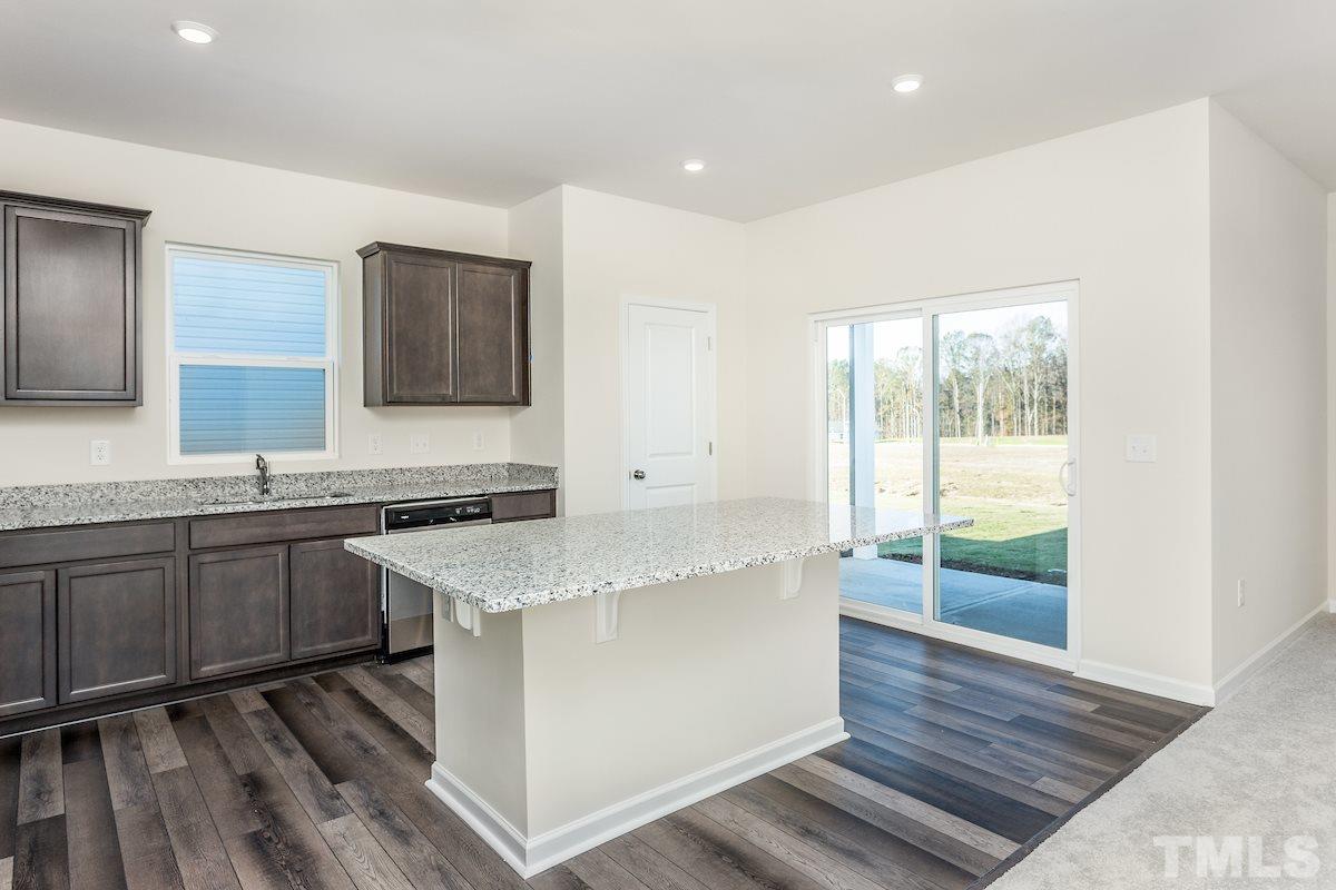3521 Strawberry Patch Row Raleigh, NC 27604 - Photo 5 of 11 a spacious bathroom with a granite countertop sink and a mirror