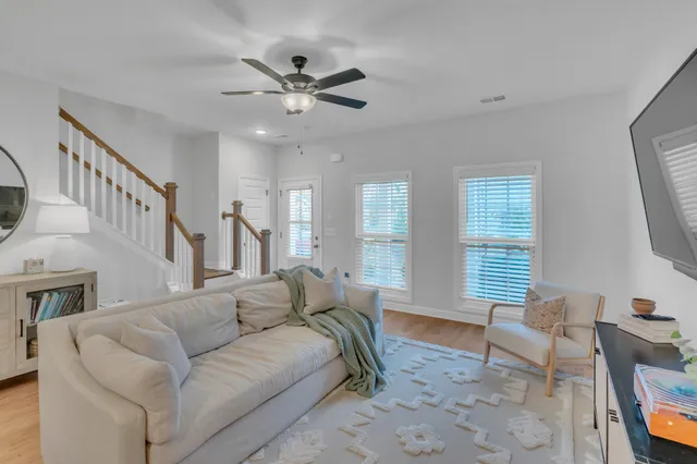a view of staircase with wooden floor and mirror