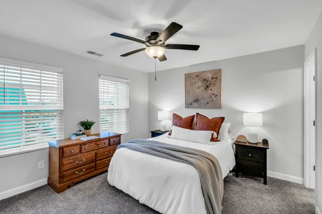 a bathroom with a double vanity sink mirror and toilet