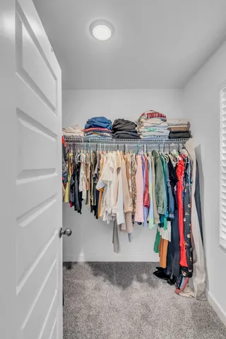 a bedroom with a bed and a book shelf