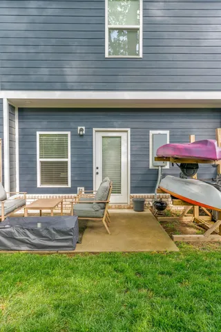 a backyard of a house with outdoor seating