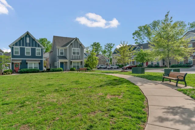 a view of a house with a yard and sitting area