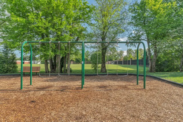a view of a house with a yard and sitting area