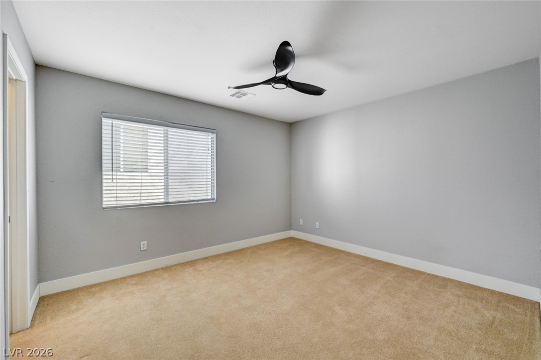 7259 Cestrum Road Las Vegas, NV 89113 - Photo 22 of 35 A well-proportioned bedroom with a contemporary ceiling fan and plush carpeted flooring awaits.