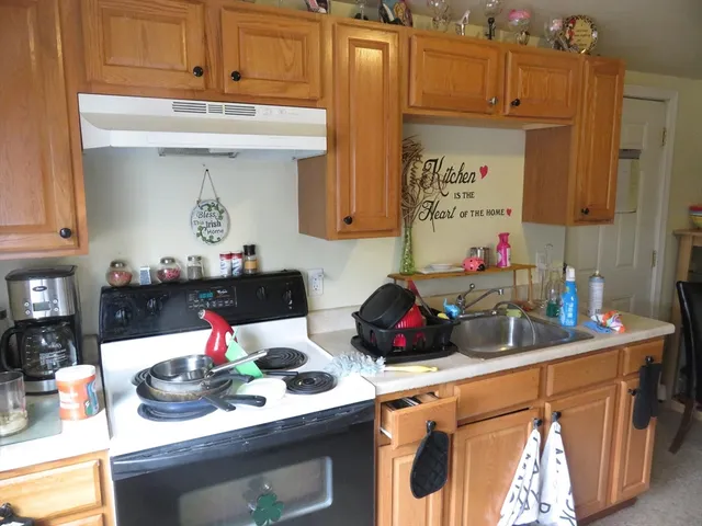 a bathroom with a granite countertop toilet sink and mirror