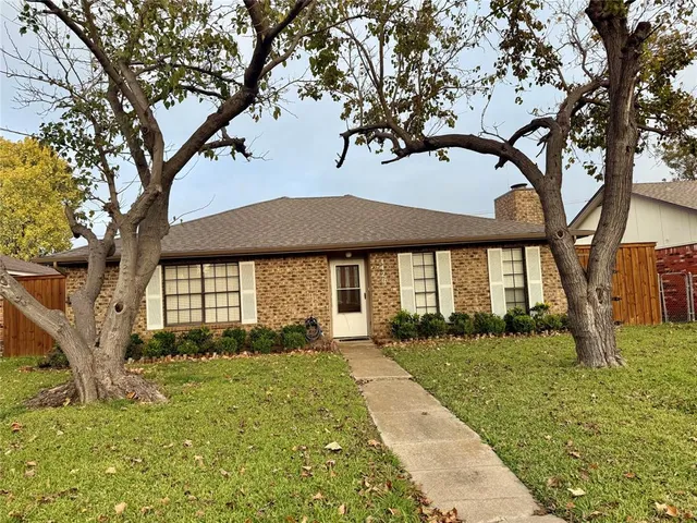 a view of a house with a tree in a yard