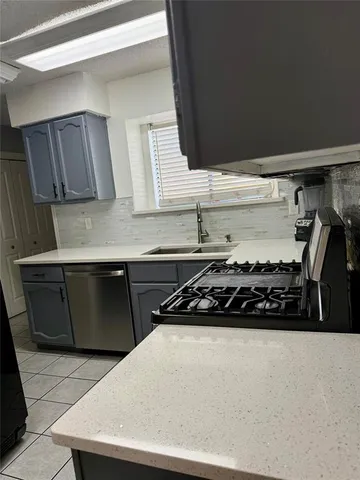 a kitchen with a stove and a refrigerator