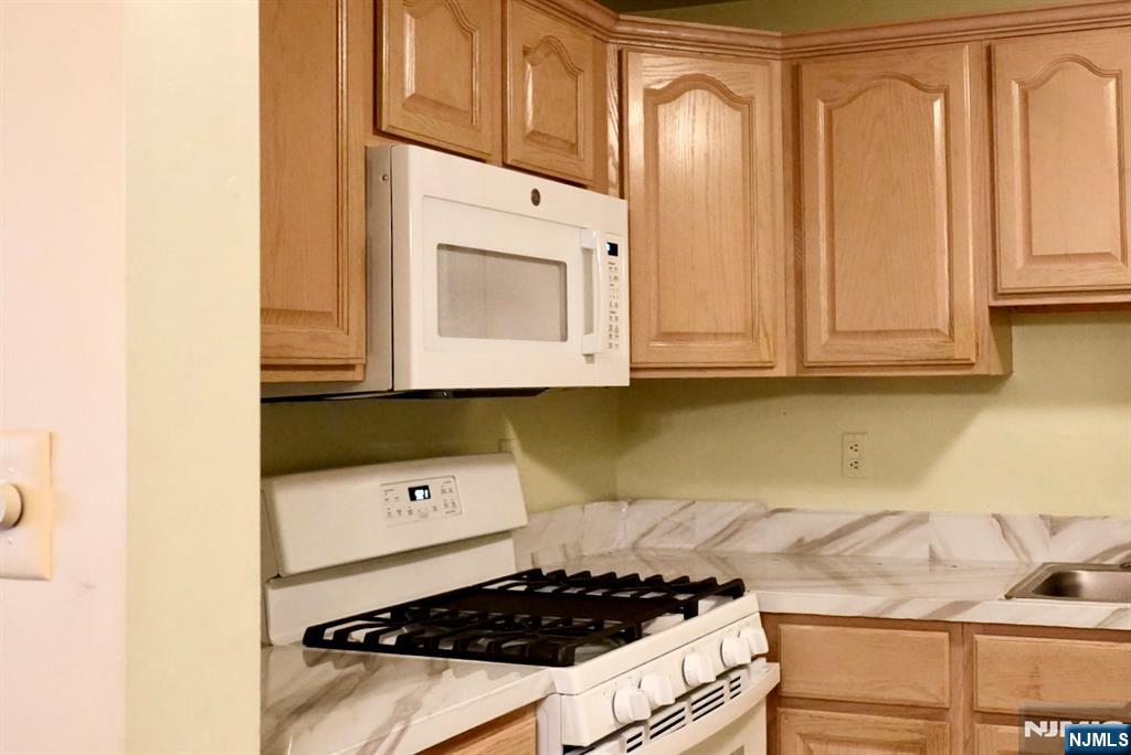 2009 Beatrice Court Mahwah, NJ 07430 - Photo 3 of 10 a kitchen with stainless steel appliances granite countertop a stove and a microwave