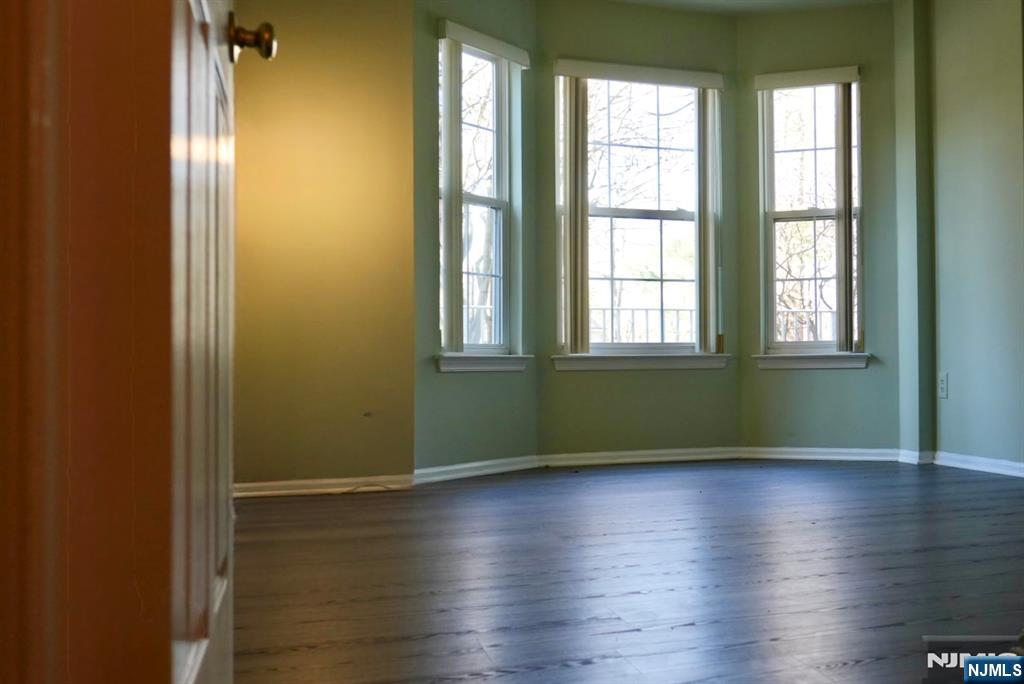2009 Beatrice Court Mahwah, NJ 07430 - Photo 6 of 10 an empty room with wooden floor and windows