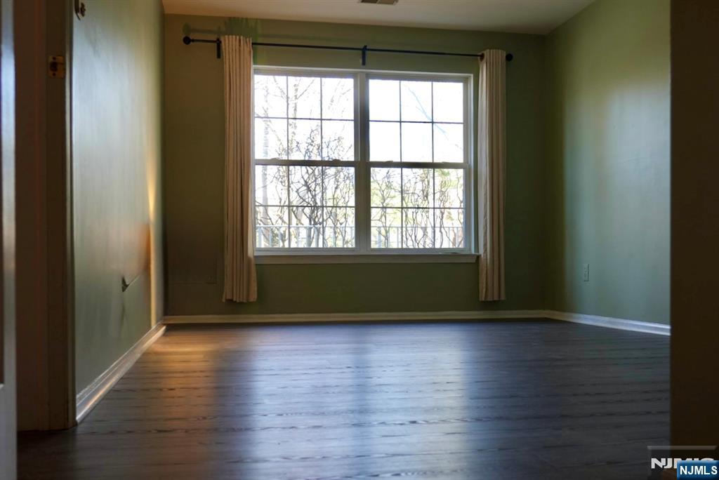 2009 Beatrice Court Mahwah, NJ 07430 - Photo 7 of 10 a view of an empty room with wooden floor and a window