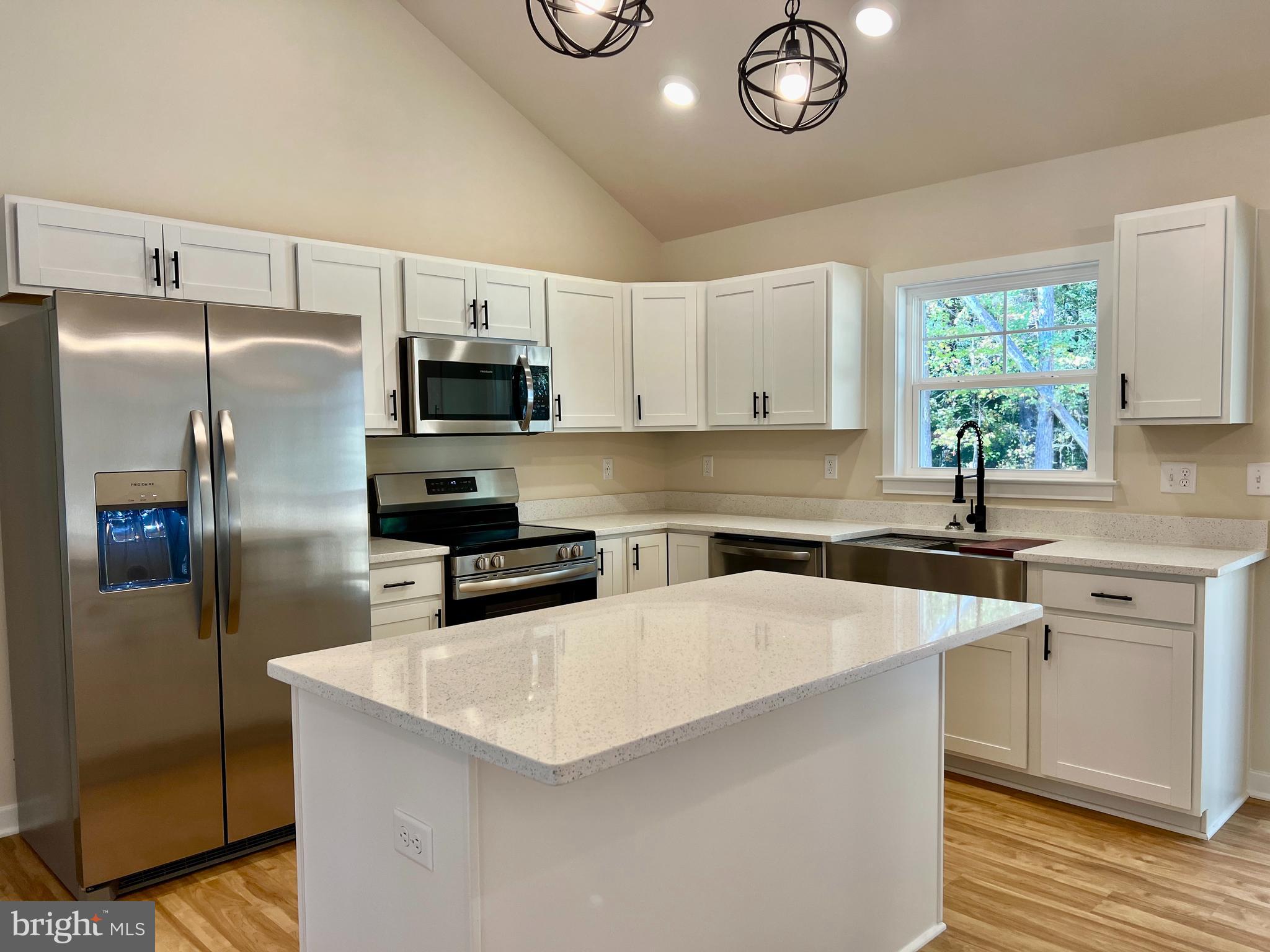 102 Azalea Way Colonial Beach, VA 22443 - Photo 3 of 10 a kitchen with stainless steel appliances a refrigerator sink and microwave
