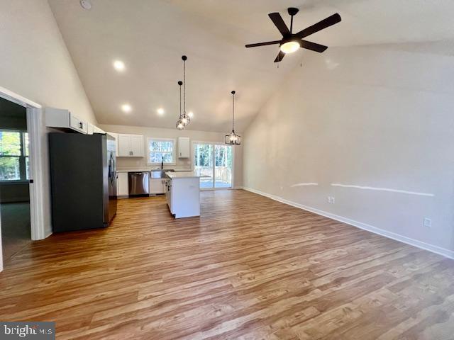 102 Azalea Way Colonial Beach, VA 22443 - Photo 5 of 10 a view of a kitchen with a refrigerator and a wooden floor