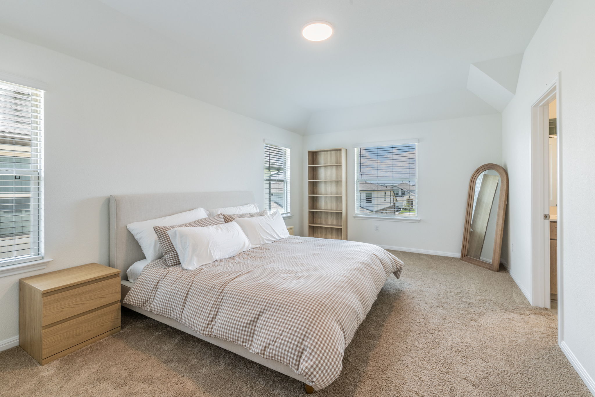 593 Backstays Loop Kyle, TX 78640 - Photo 8 of 26 a spacious bedroom with a bed and a window