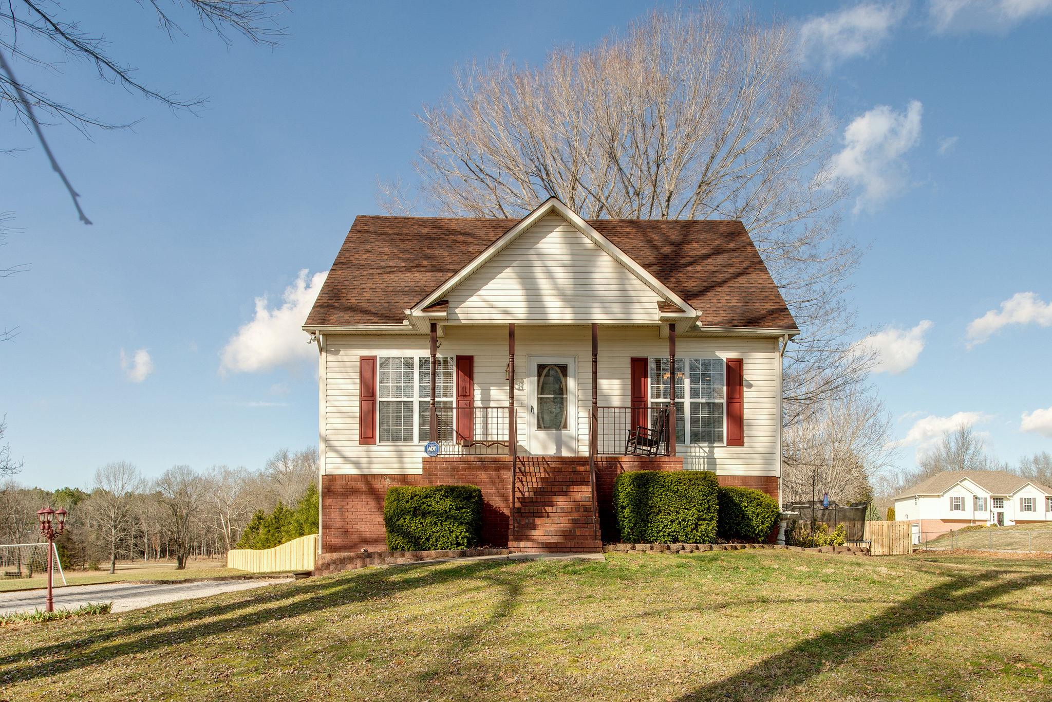 1967 Lasea Road Spring Hill, TN 37174 - Photo 1 of 30 a view of a house with a yard and table and chairs under an umbrella