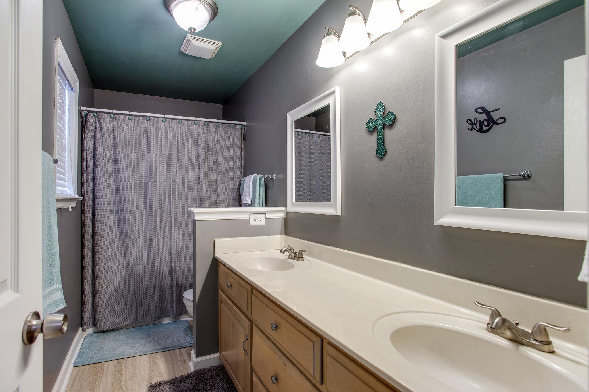 1967 Lasea Road Spring Hill, TN 37174 - Photo 15 of 30 a bathroom with a double vanity sink and a mirror