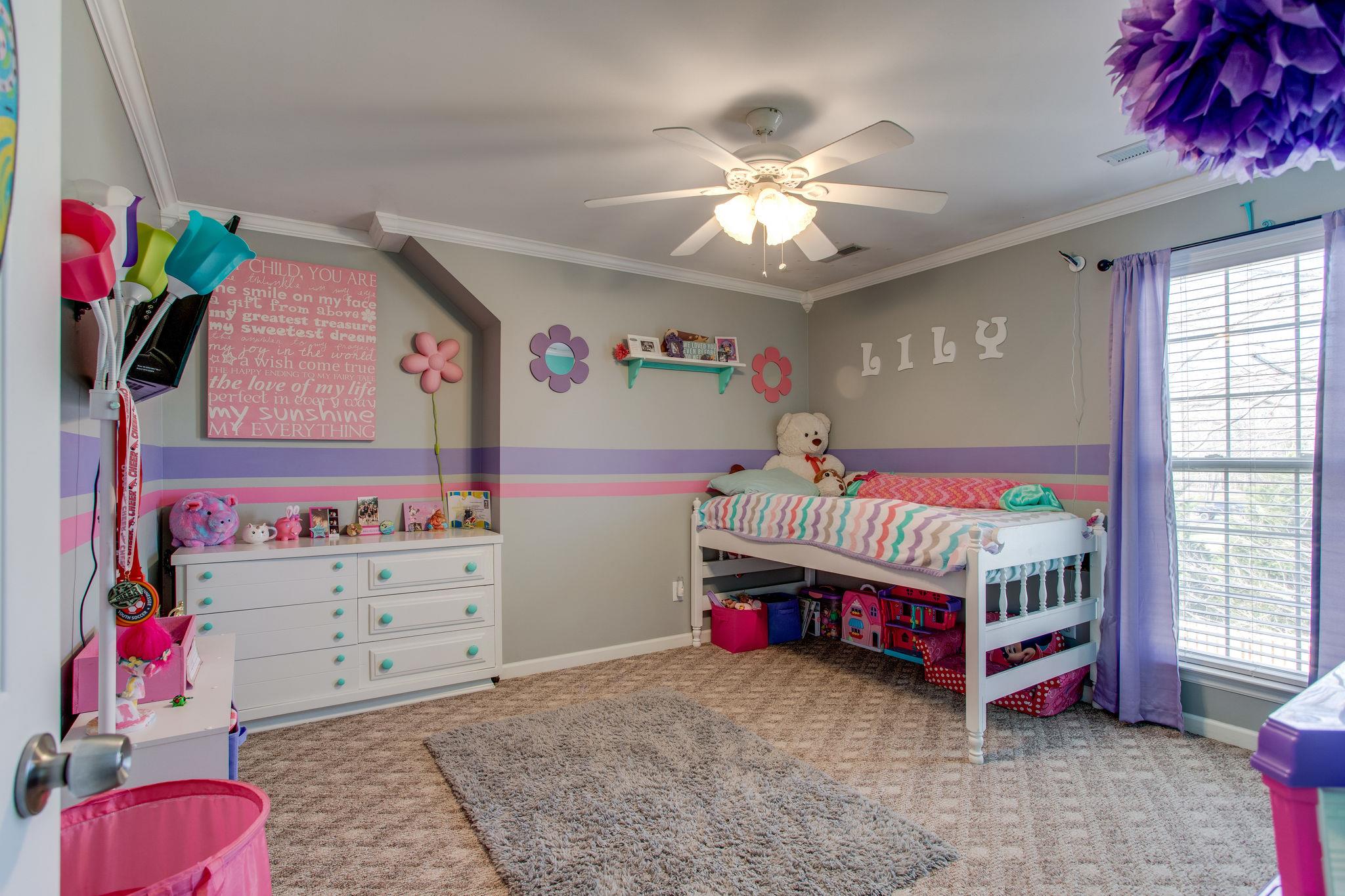 1967 Lasea Road Spring Hill, TN 37174 - Photo 16 of 30 a bedroom with furniture and a chandelier