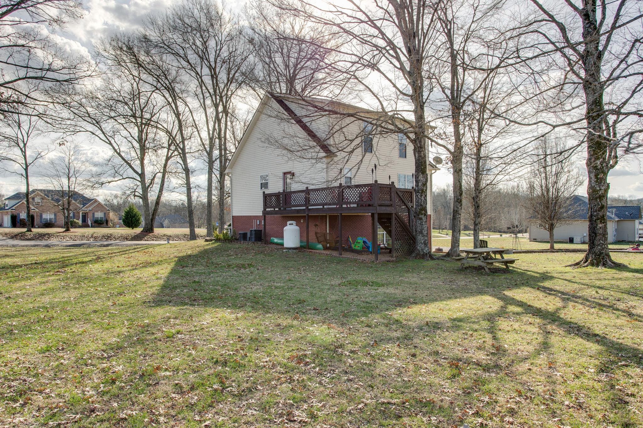 1967 Lasea Road Spring Hill, TN 37174 - Photo 25 of 30 a view of a yard with a house and a tree