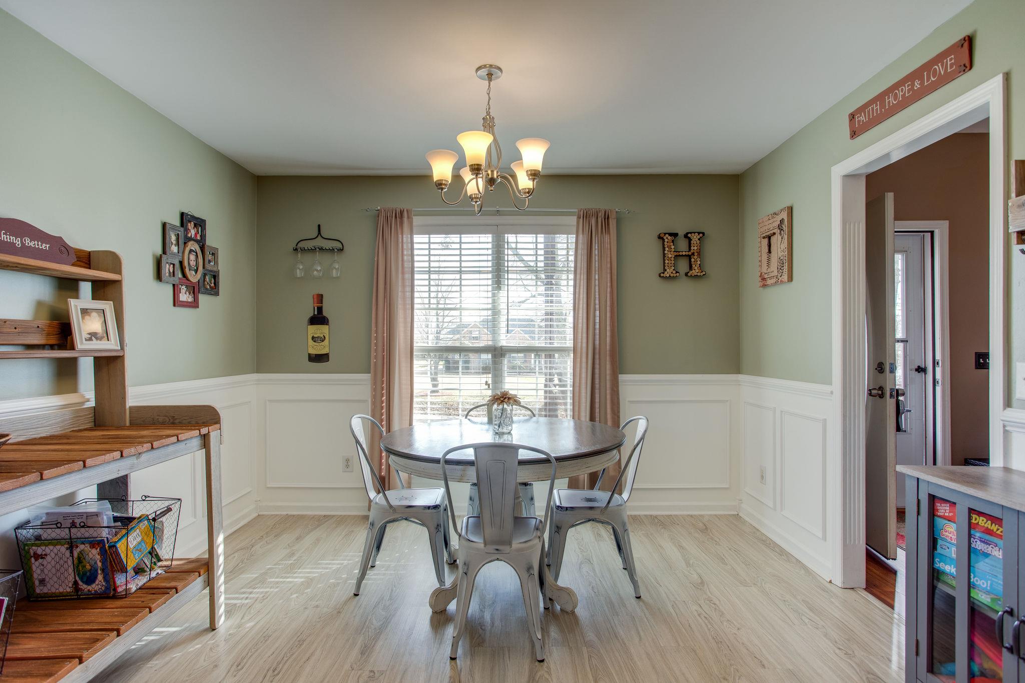 1967 Lasea Road Spring Hill, TN 37174 - Photo 7 of 30 a view of a dining room with furniture a chandelier and wooden floor