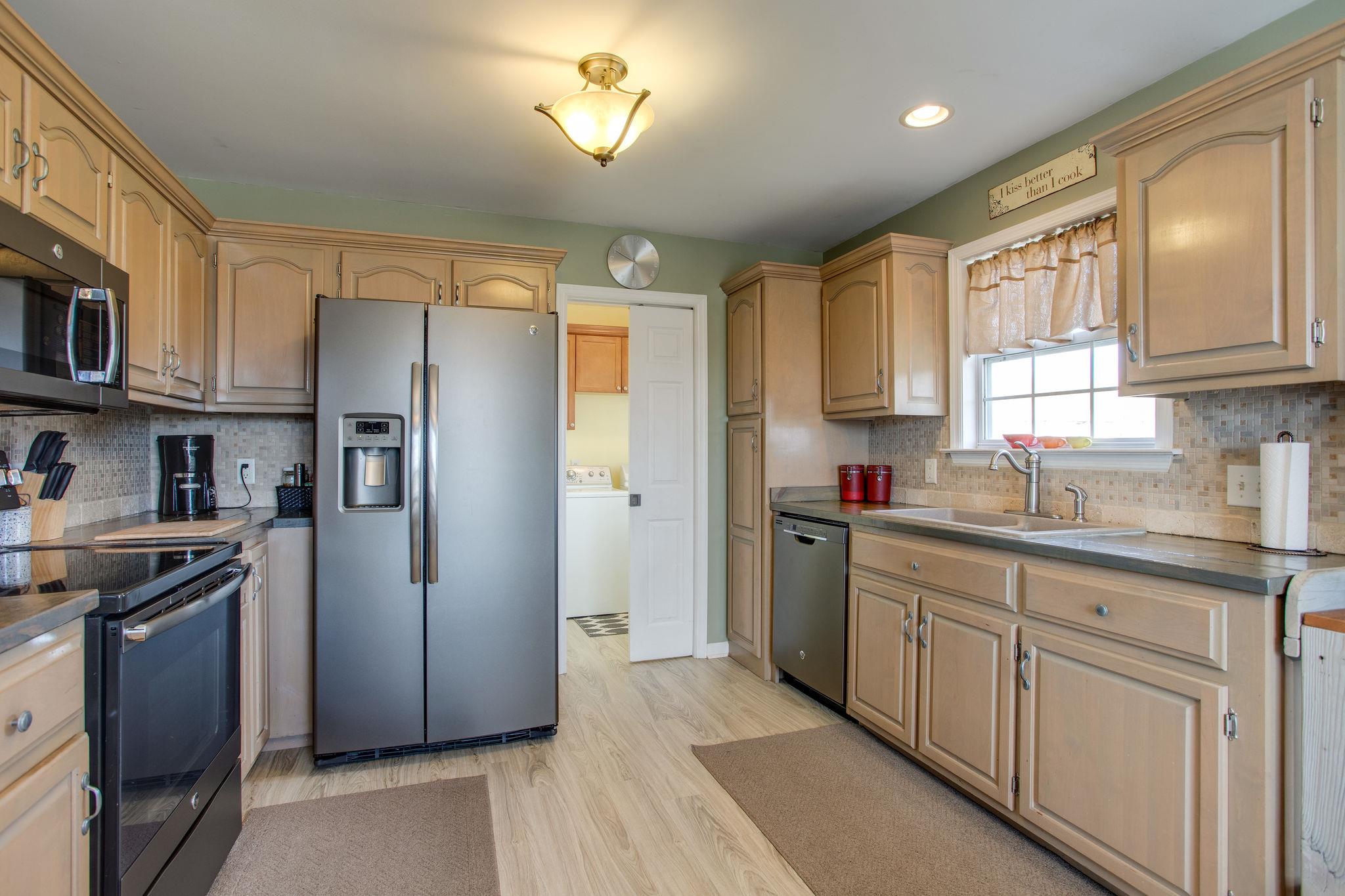 1967 Lasea Road Spring Hill, TN 37174 - Photo 9 of 30 a kitchen with stainless steel appliances granite countertop a refrigerator and a sink