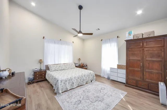 a living room with furniture and a ceiling fan