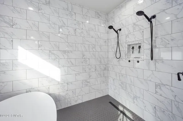 a living room with furniture a rug and a table