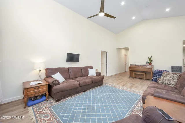 a spacious bathroom with a double vanity sink toilet mirror and bathtub