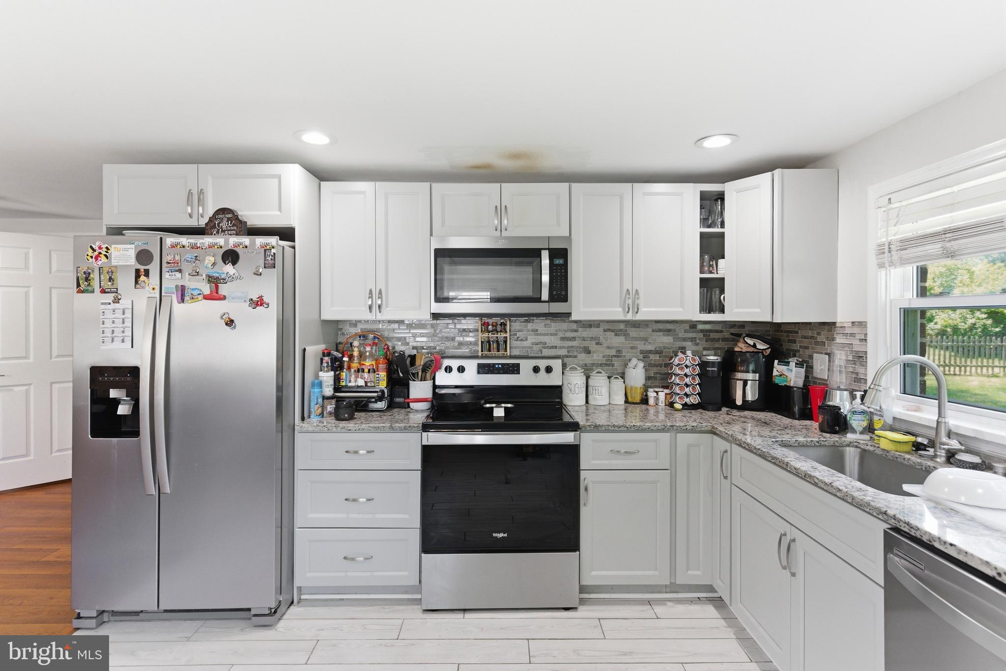 912 Shelley Road Towson, MD 21286 - Photo 12 of 27 a kitchen with stainless steel appliances granite countertop a refrigerator stove and sink