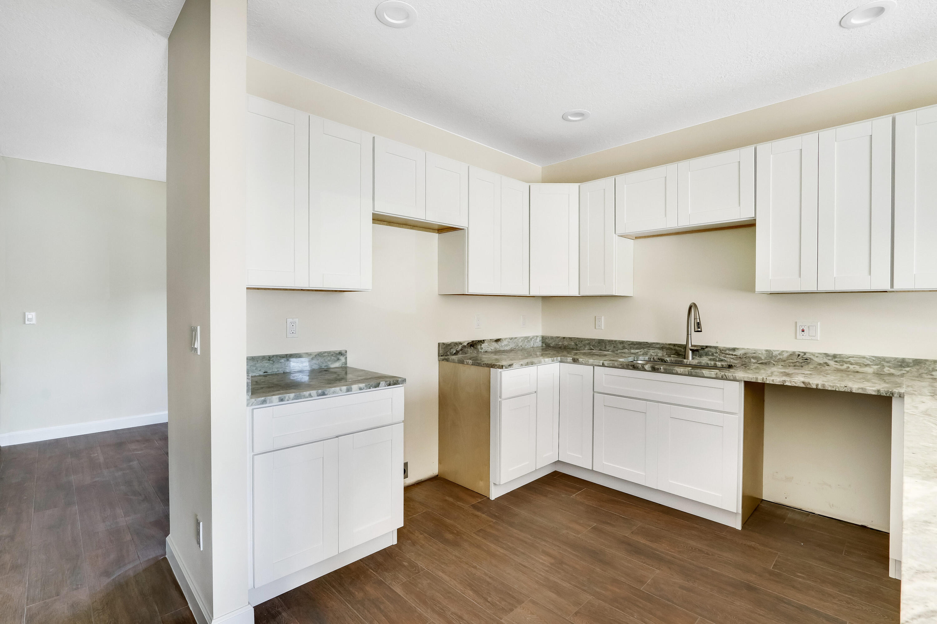 936 Southeast 6th Street Stuart, FL 34994 - Photo 13 of 25 a kitchen with granite countertop white cabinets and white appliances