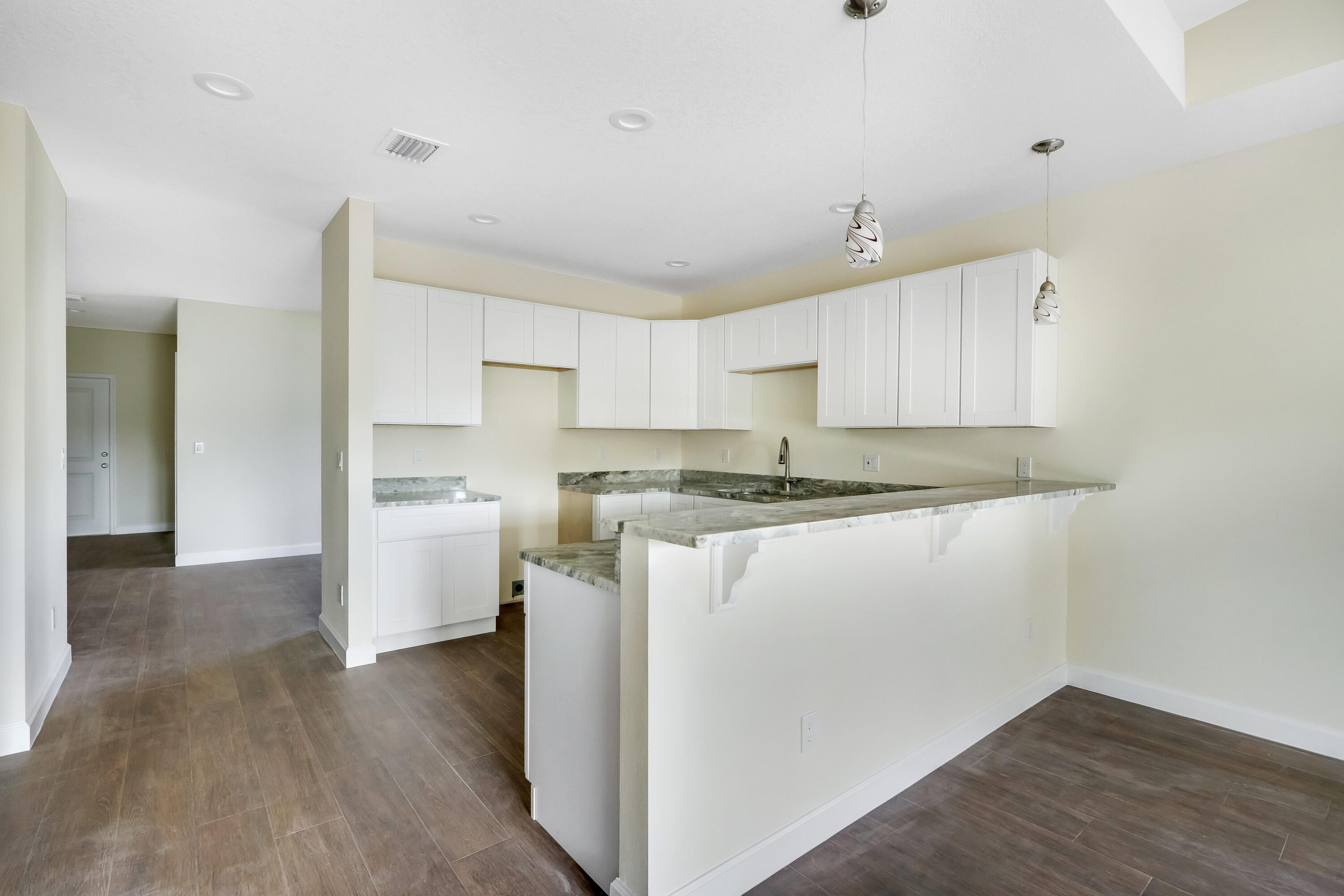 936 Southeast 6th Street Stuart, FL 34994 - Photo 14 of 25 a kitchen with a refrigerator sink and cabinets