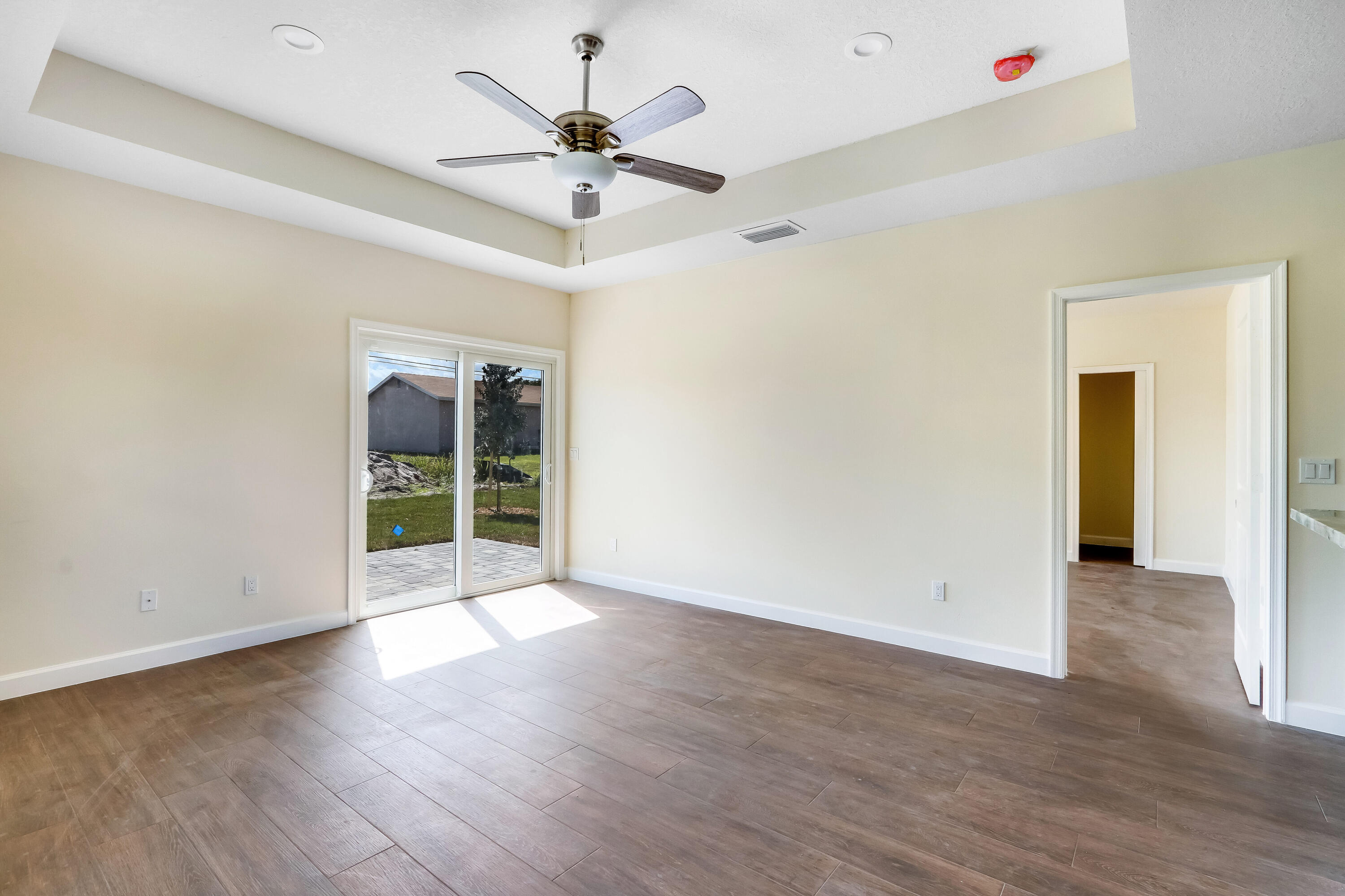 936 Southeast 6th Street Stuart, FL 34994 - Photo 18 of 25 a view of an empty room with wooden floor and a ceiling fan