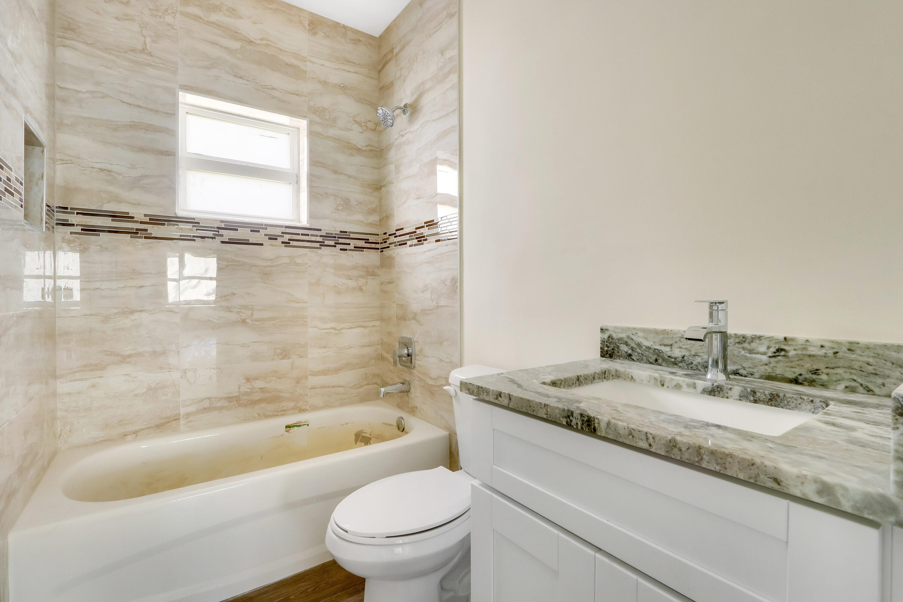936 Southeast 6th Street Stuart, FL 34994 - Photo 23 of 25 a bathroom with a granite countertop toilet sink and bathtub
