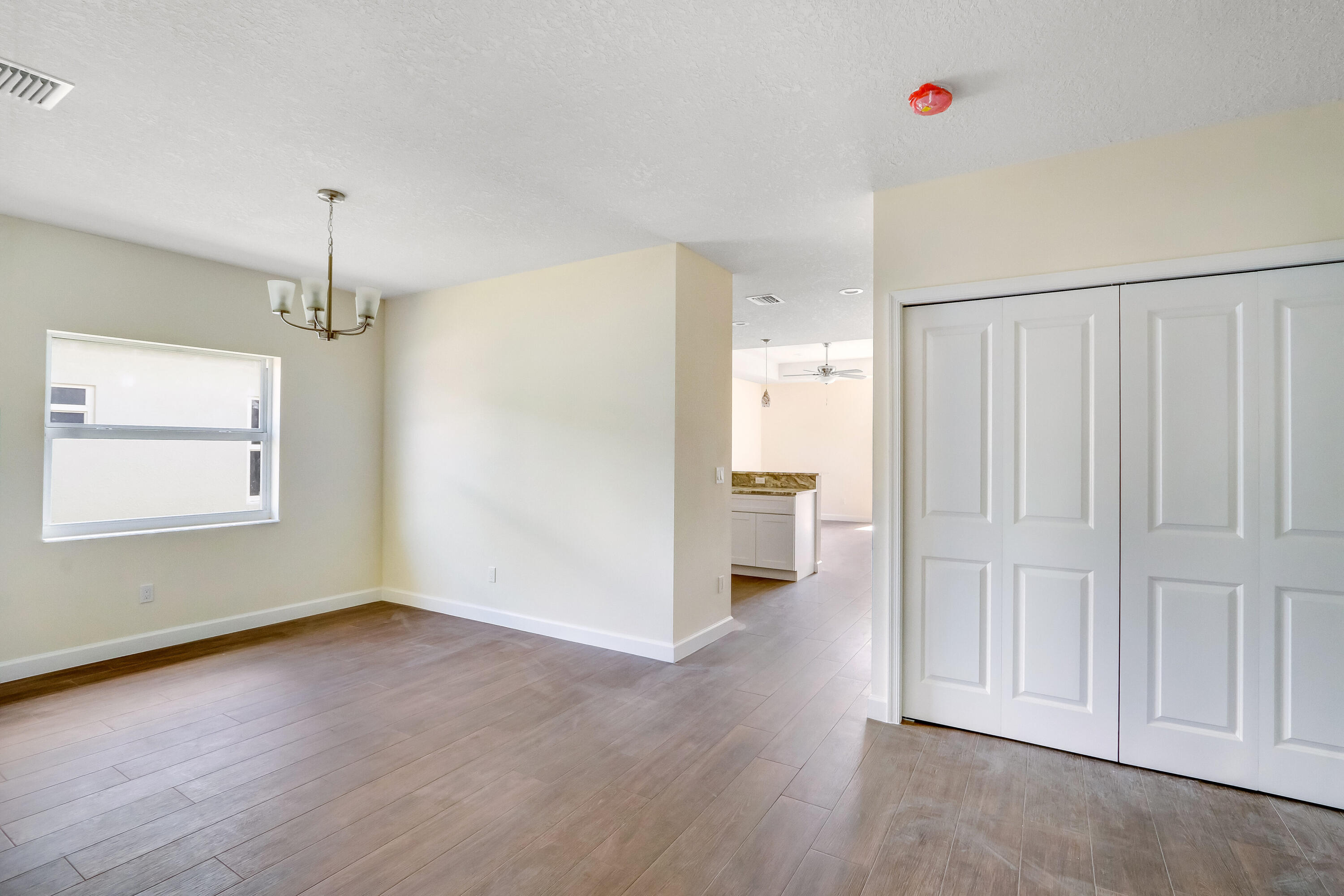 936 Southeast 6th Street Stuart, FL 34994 - Photo 9 of 25 wooden floor in an empty room and a window