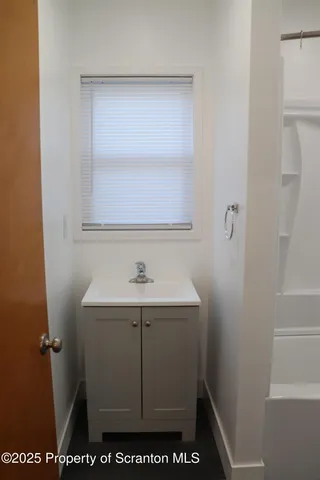 an empty room with wooden floor and closet