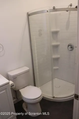 a bathroom with a toilet a sink and a mirror