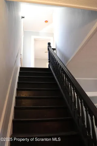 a view of hallway with closet and a window