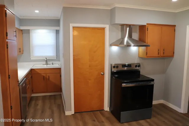 a kitchen with a refrigerator and a stove