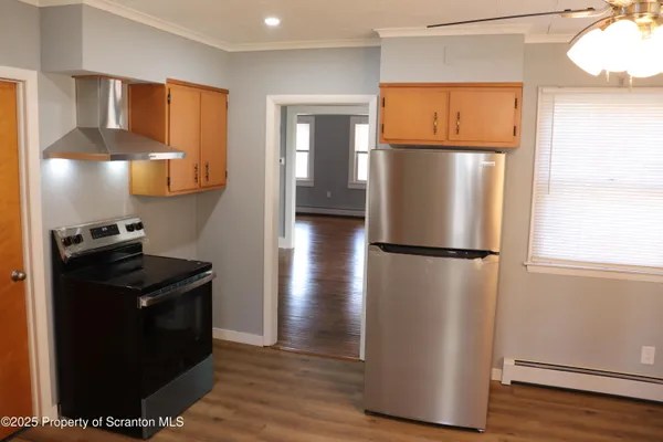 a view of a refrigerator in kitchen and wooden floor