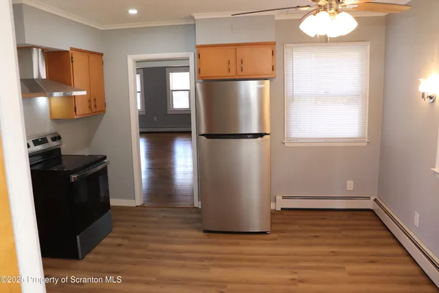 a view of a refrigerator in kitchen and wooden floor