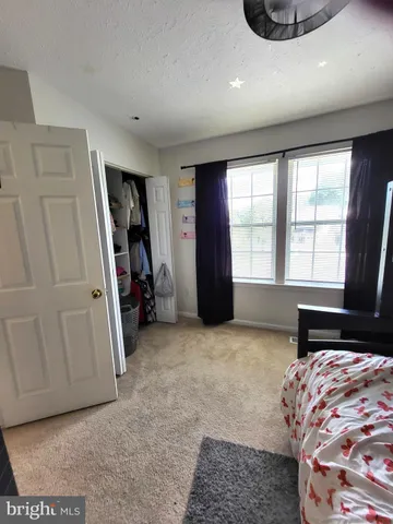 a bedroom with bed and window