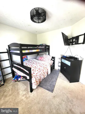 a bedroom with a bed and a chair