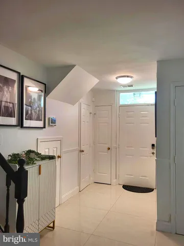 a view of kitchen with granite countertop cabinets and window