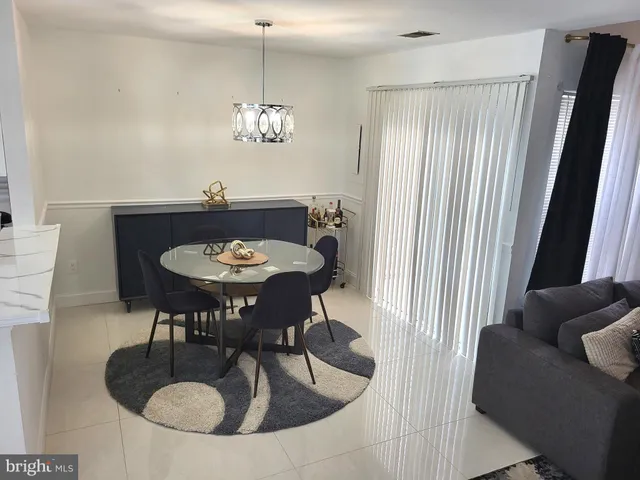 a view of a livingroom and dining area with a couch