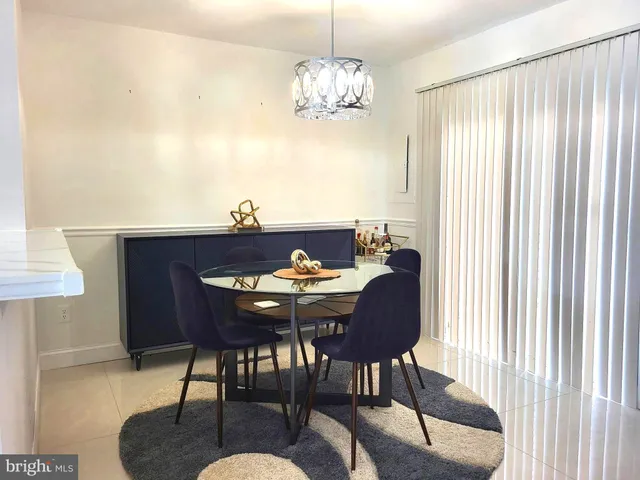 a view of a dining room with furniture and chandelier