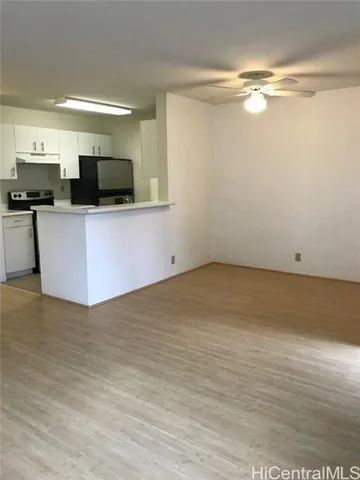 a view of kitchen with stainless steel appliances kitchen island microwave and cabinets