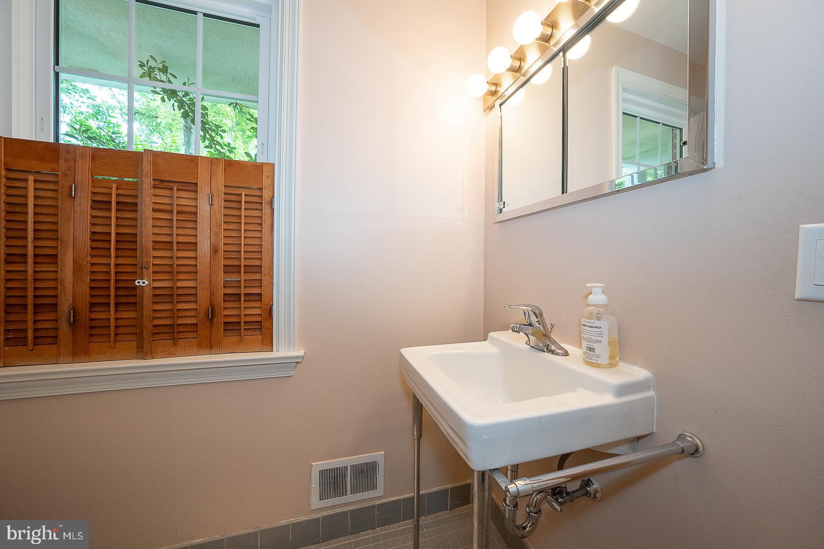 538 Conestoga Road Villanova, PA 19085 - Photo 14 of 39 a bathroom with a sink window and a mirror