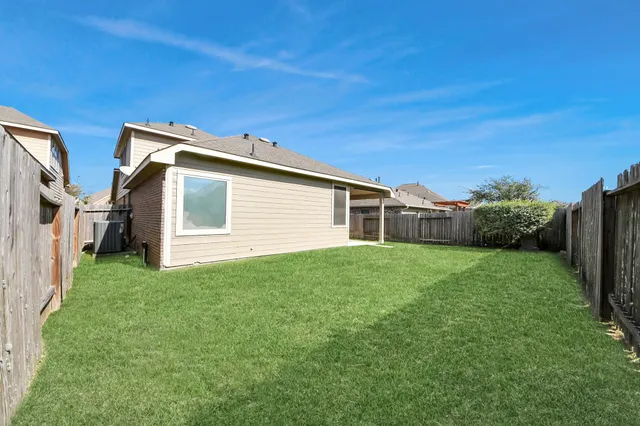 a aerial view of multi story residential apartment building with yard and outdoor seating