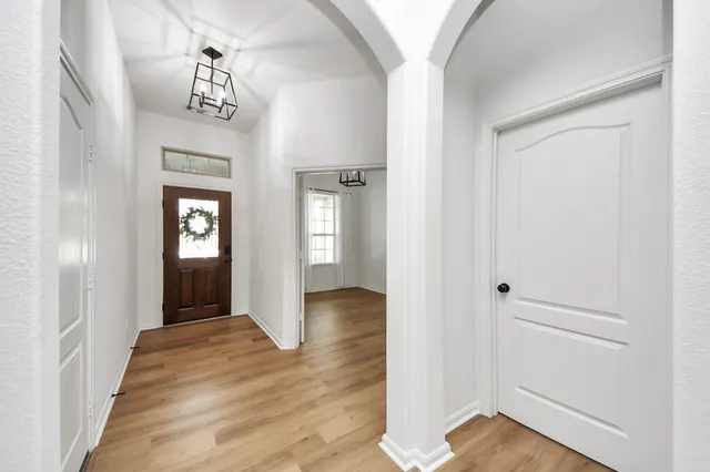 a view of a hallway with wooden floor