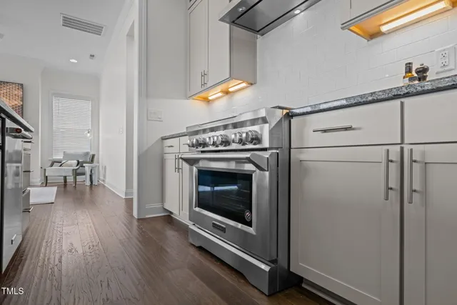 a kitchen with lots of counter space a sink appliances and living room view